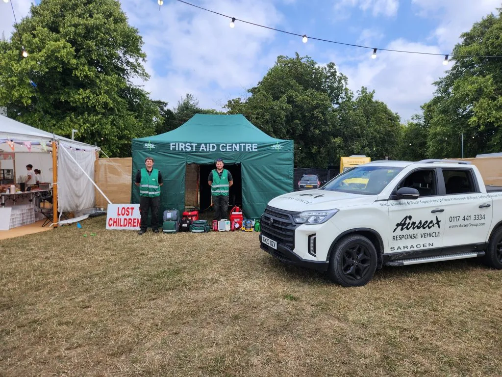 Airsec first aid centre tent and medical response vehicle at an outdoor event